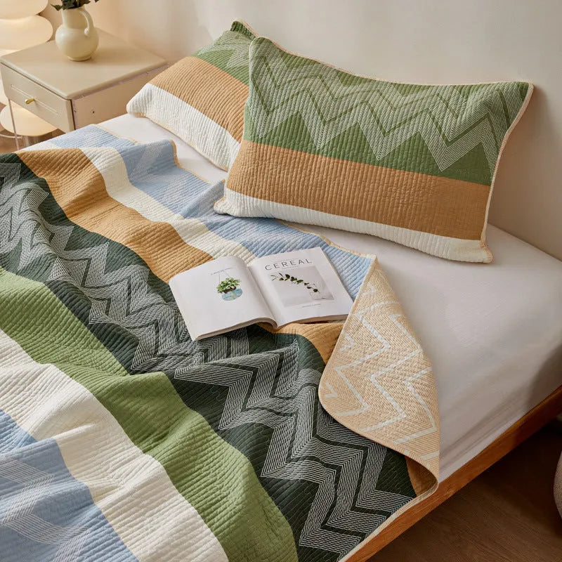 Pure cotton floral printed bed sheet and pillowcases laid flat on a bed.