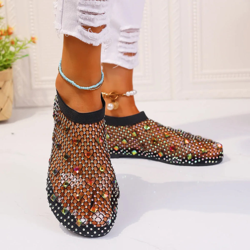Colourful rhinestone detail on women's mesh flat sandals with round toe and rubber sole.