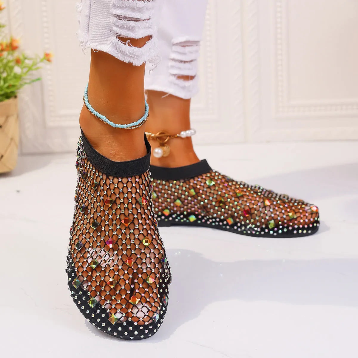 Colourful rhinestone detail on women's mesh flat sandals with round toe and rubber sole.