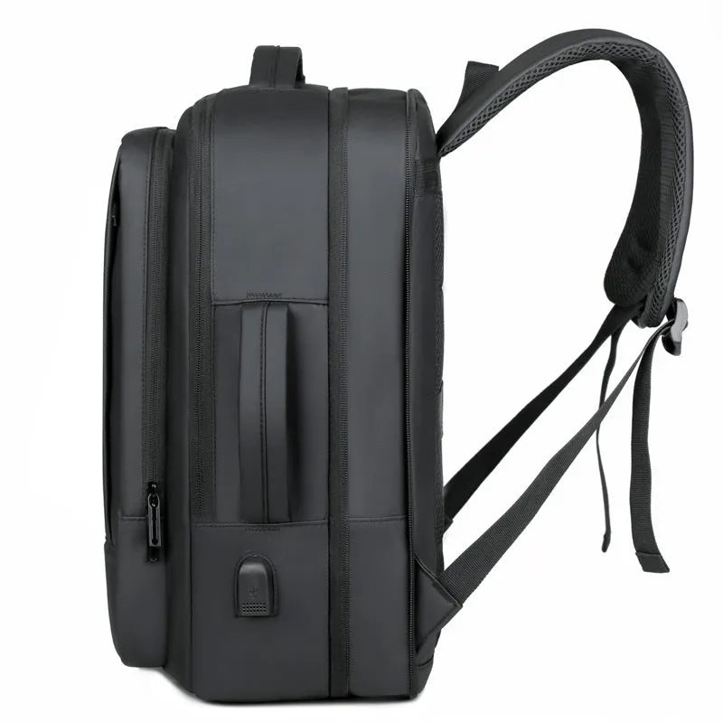 Large black waterproof Oxford cloth backpack with curved shoulder straps on a grey background.