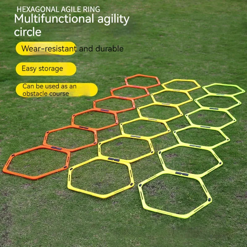 Set of six brightly coloured foldable hexagon football agility training rings on grass