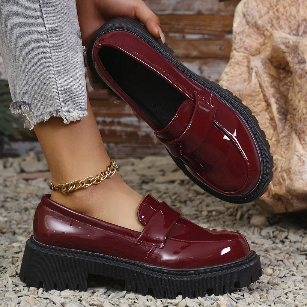 Plus size black chunky heel loafers with a thick rubber sole and slip-on design.