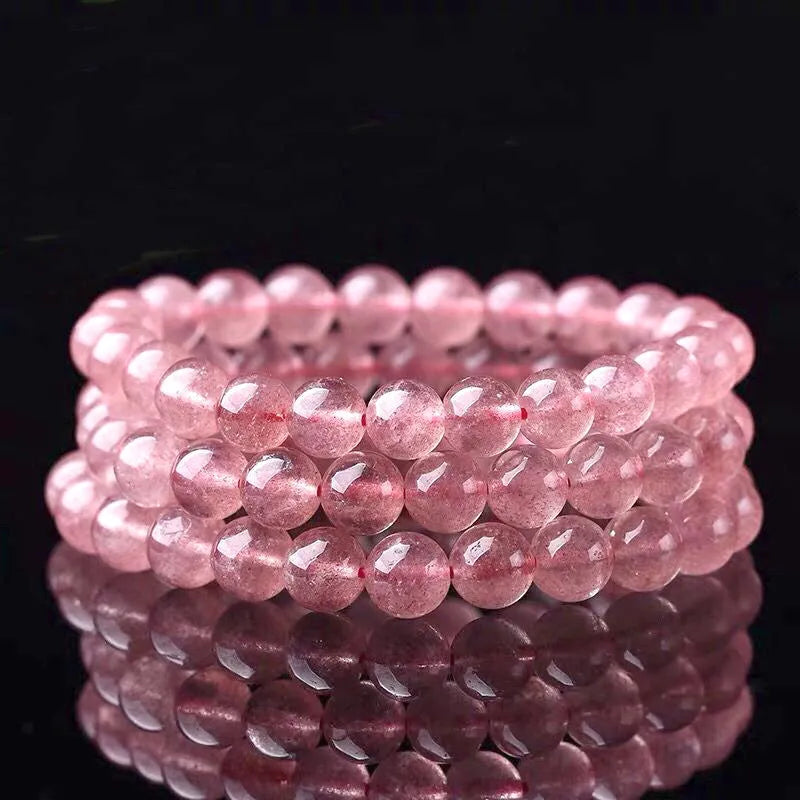 Women's adjustable bracelet made from polished strawberry quartz beads in 6mm, 8mm, or 10mm sizes.