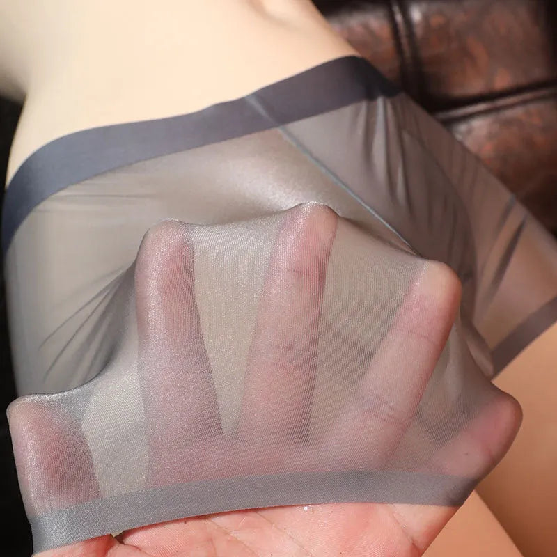 Ultra-thin transparent men's ice silk boxer shorts in light grey on a size chart.