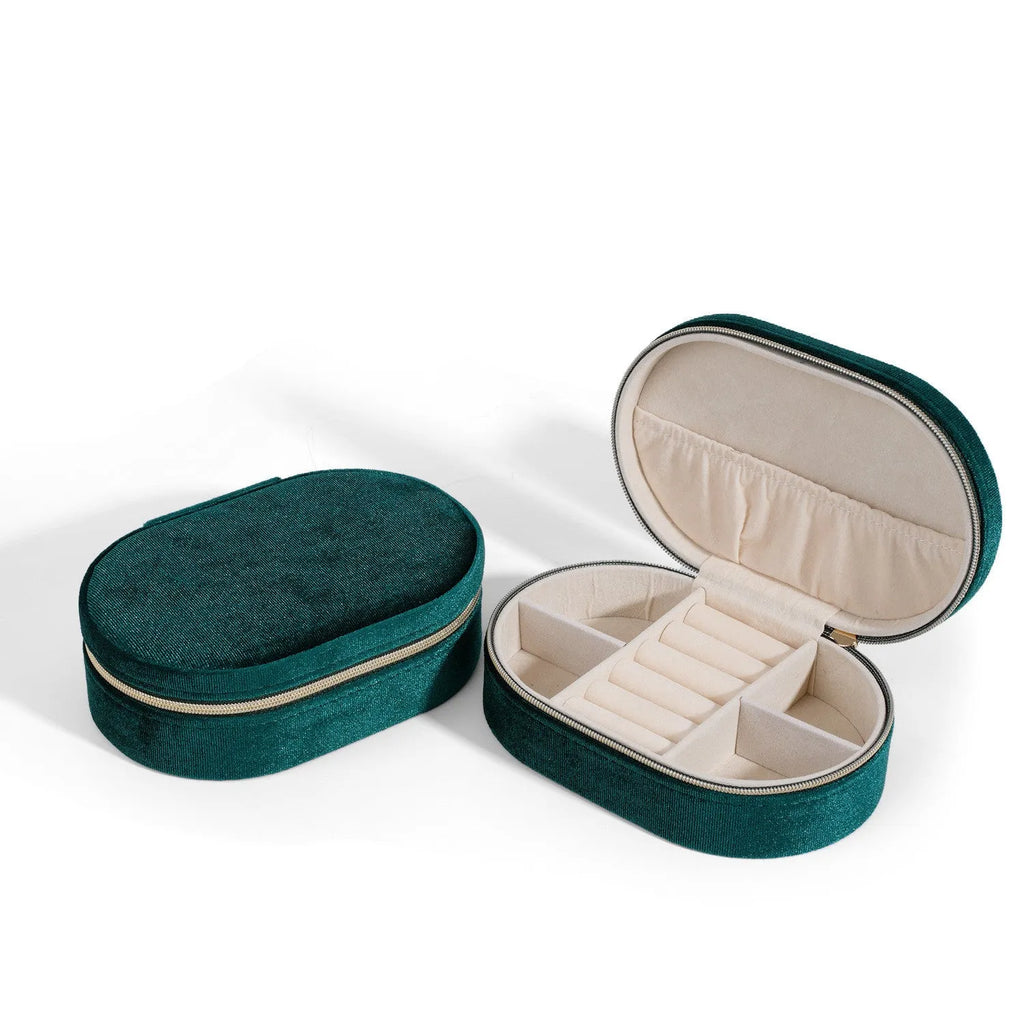 Oval velvet jewellery box in lake blue colour with flannel interior, shown with dimensions 15cm by 10cm.