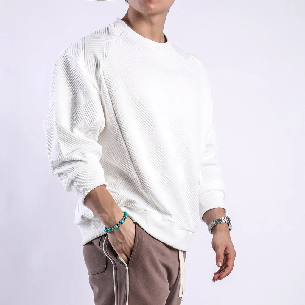 Men's loose fit long sleeve twill Jacquard sweater in solid colours on a hanger.