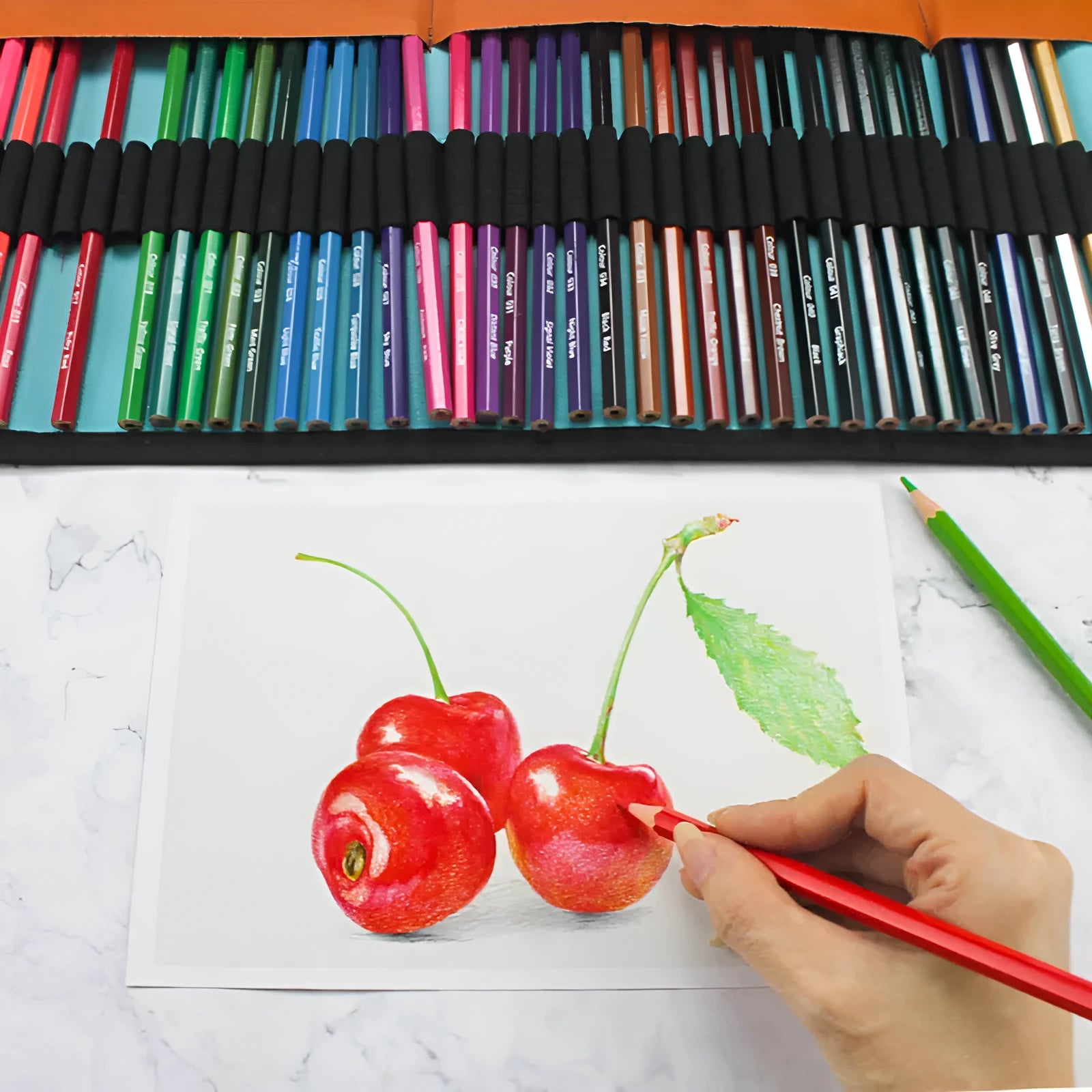 Set of fifty wooden coloured pencils in assorted colours stored in a brown rectangular case.