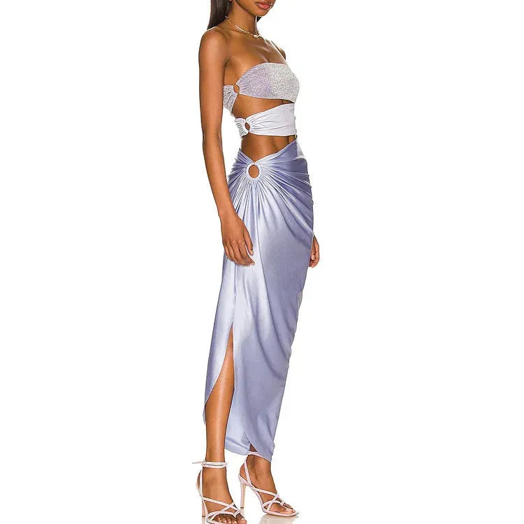 Purple women's one-piece swimsuit with matching wrap skirt on beach
