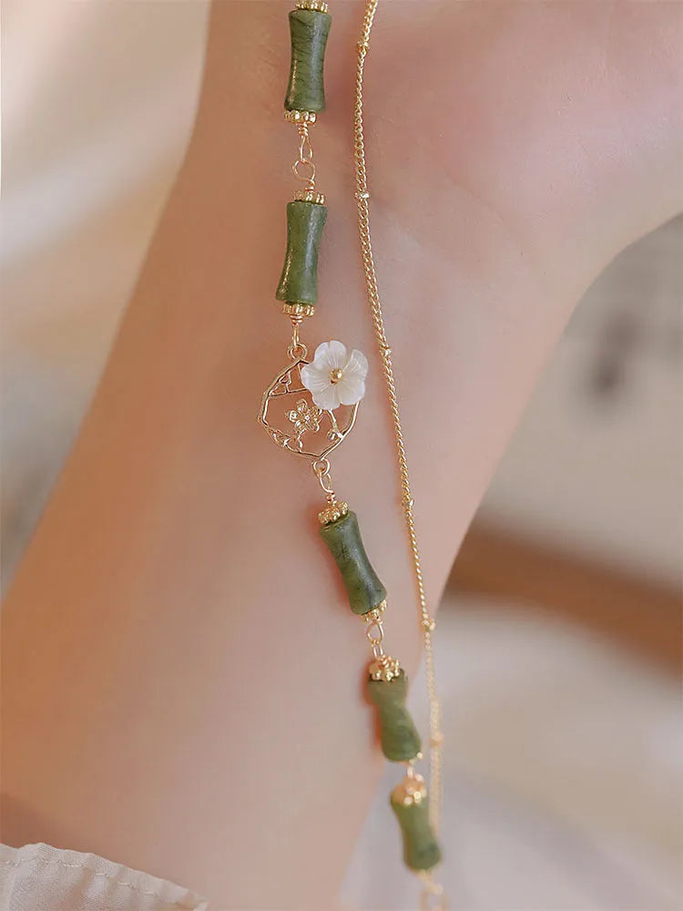 Natural green olivine bracelet with double layer design featuring olive branches and bells of Ireland motifs