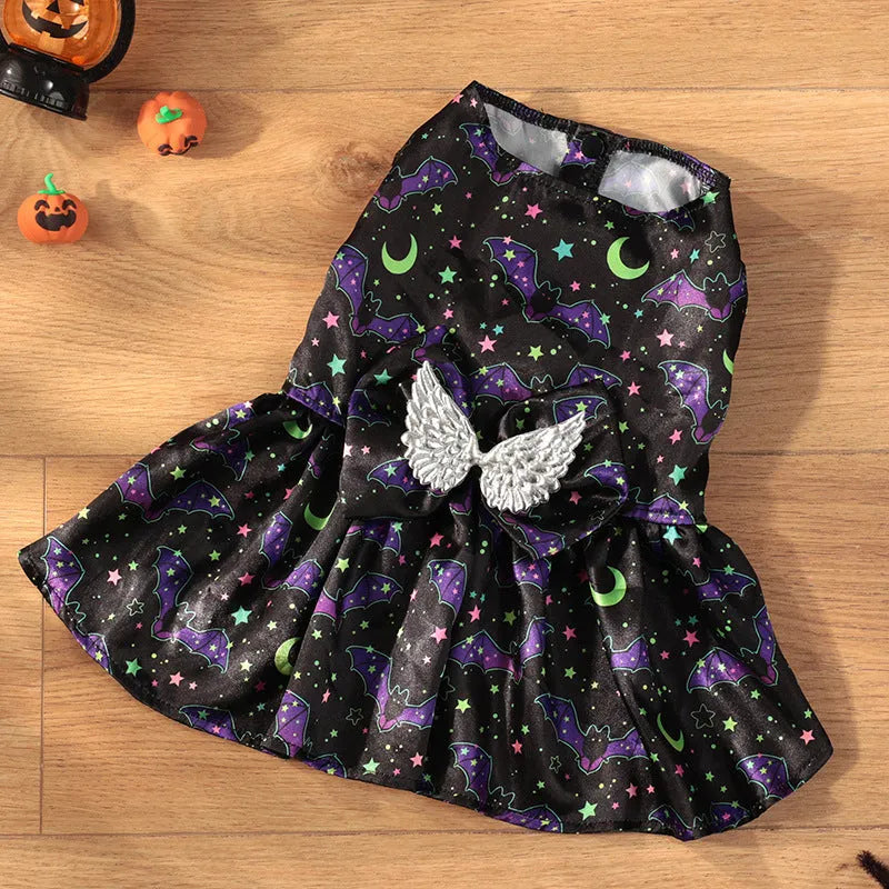 Dog wearing an angel wings Halloween costume in bright orange or purple colours