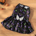 Dog wearing an angel wings Halloween costume in bright orange or purple colours