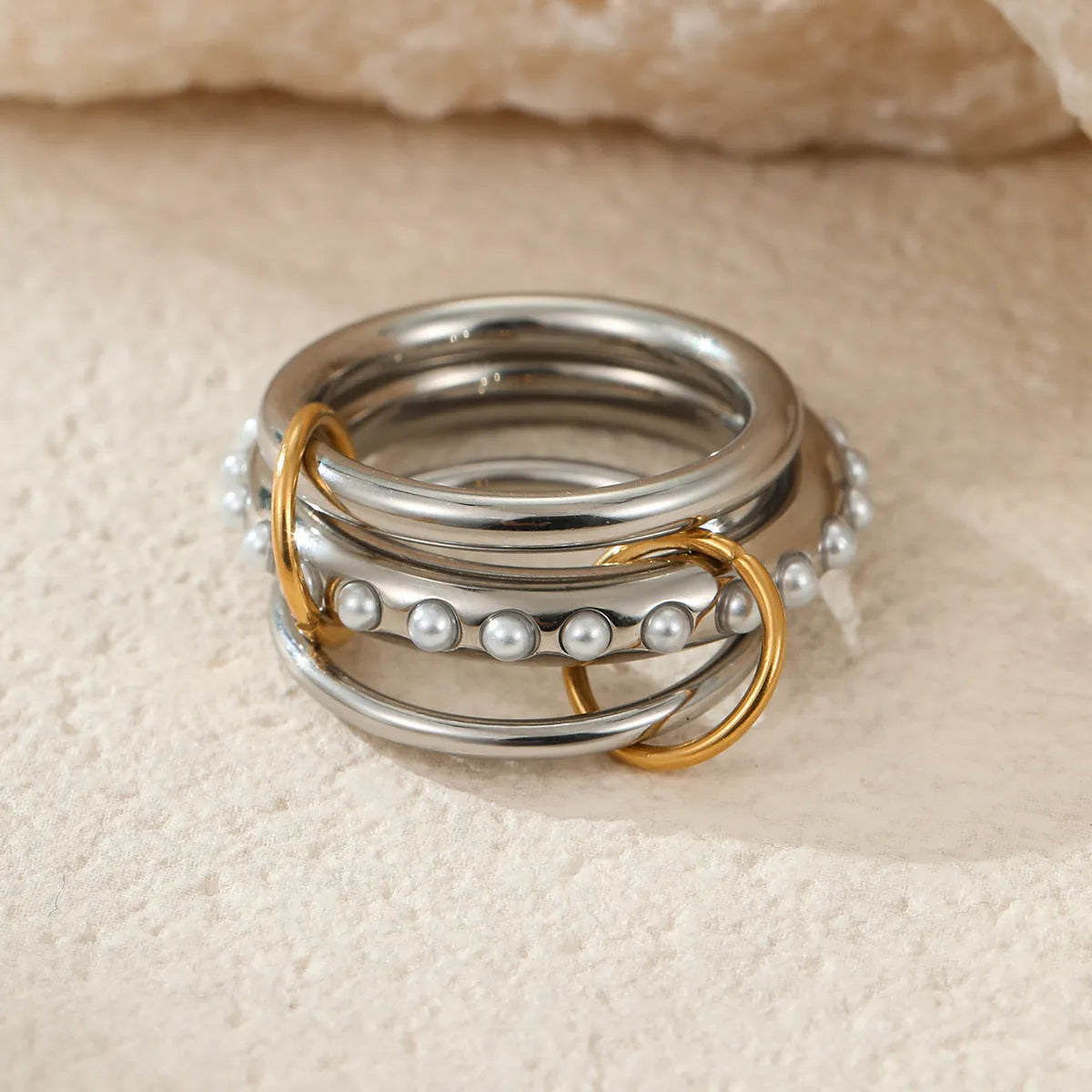 Stackable stainless steel rings with 18K gold plating in colour matching bands, exaggerated modern design