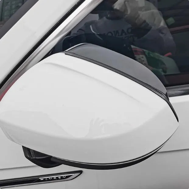 Pair of Mazda reversing mirror rain barrier strips in carbon fibre pattern on a Mazda CX5 side mirror