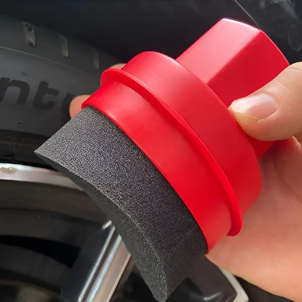 Black tyre polishing sponge brush with lid on a car tyre, showing high-density sponge applicator head.
