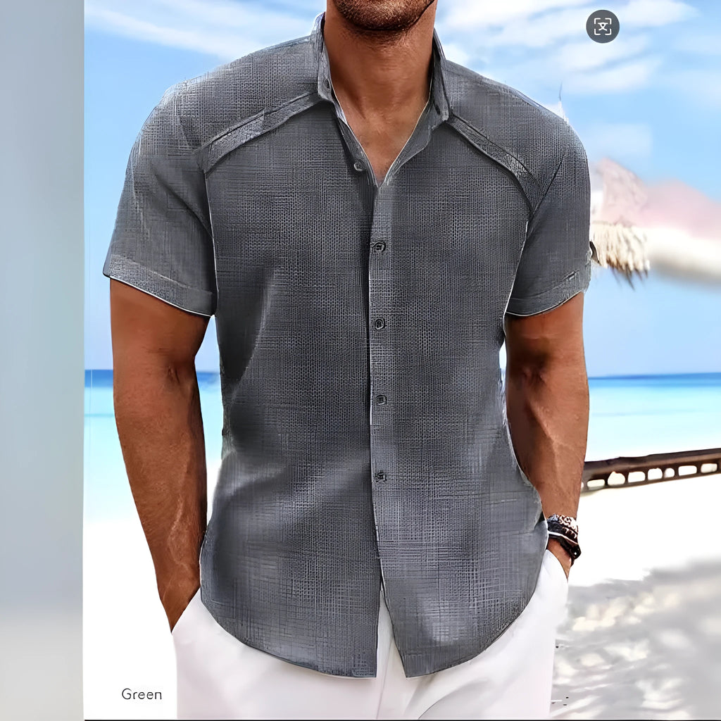 Man wearing a solid colour short sleeve Hawaiian casual shirt in a cotton blend fabric.