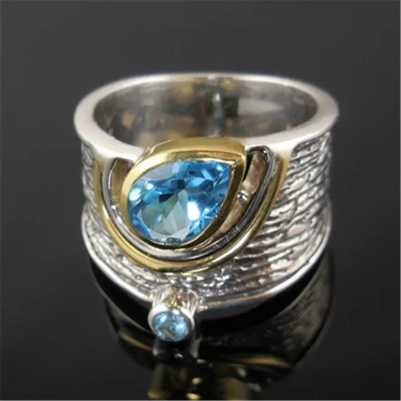 Women's blue zircon ring with Chinese style design and drop shape, shown in alloy.