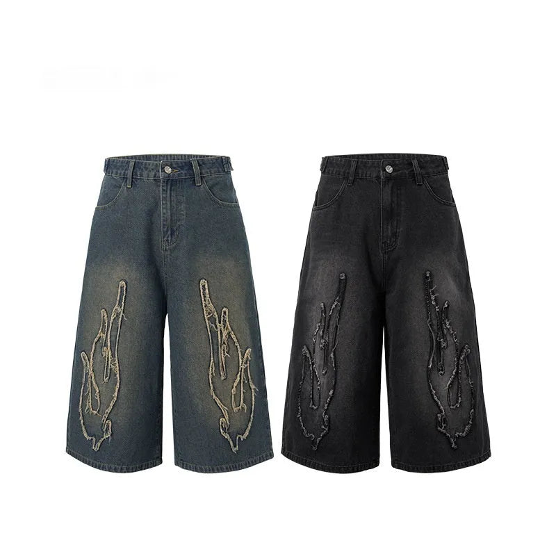 Men's black denim shorts with flame embroidery patch and straight leg cropped cut
