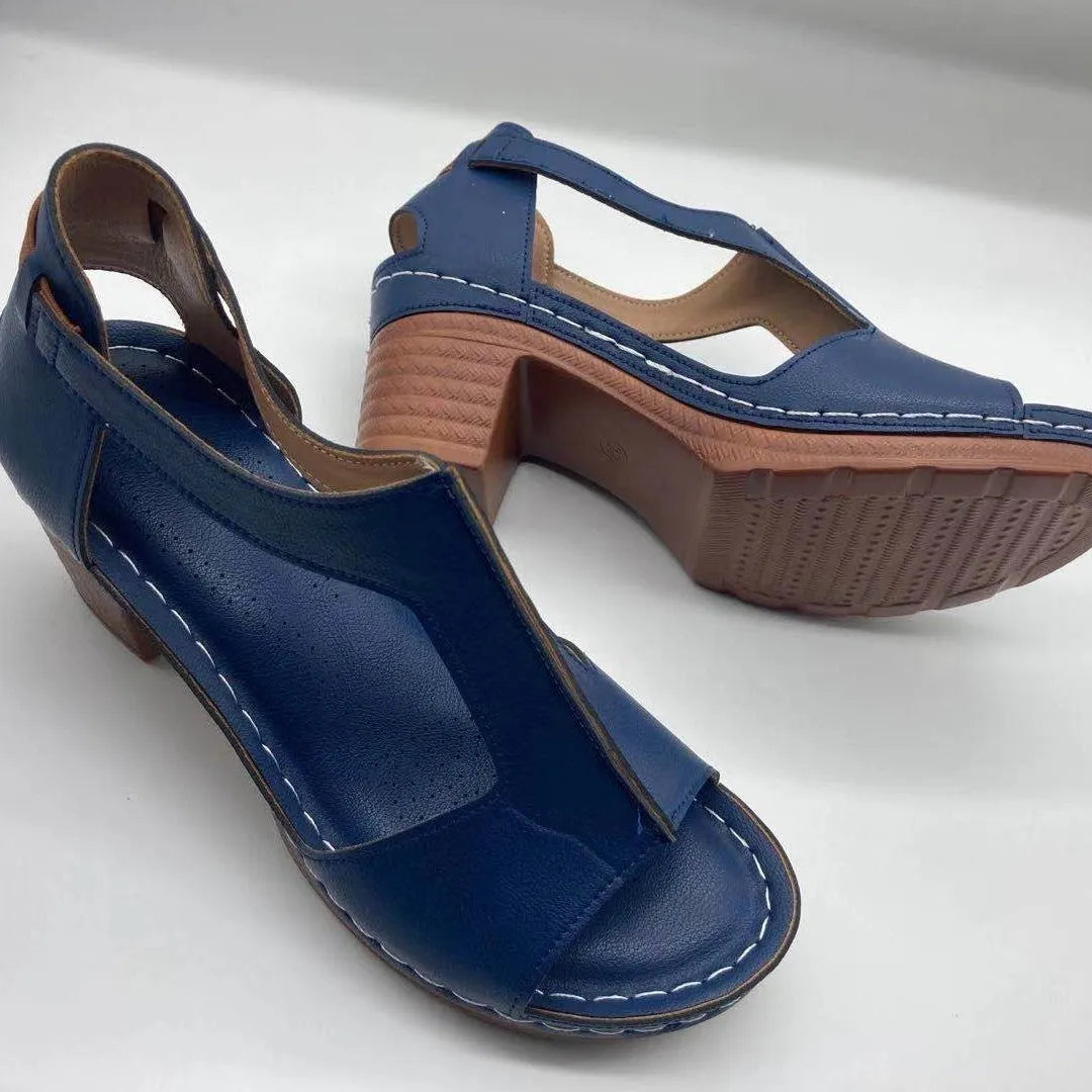 Women's plus size beige peep toe wedge sandals with a buckle strap and low heel.