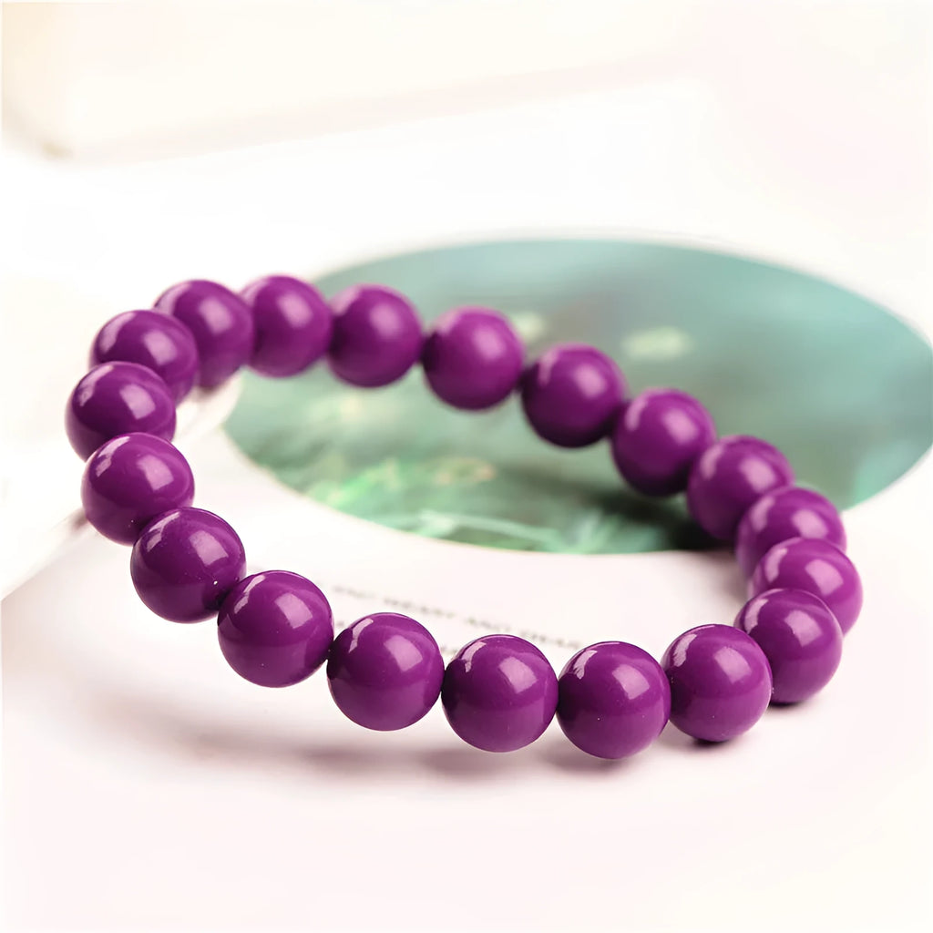 Jiuya polished crystal bracelet in purple mica colour, showing single strand of round beads.