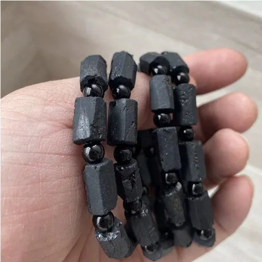 Natural black tourmaline rough stone bracelet with unpolished beads on wrist