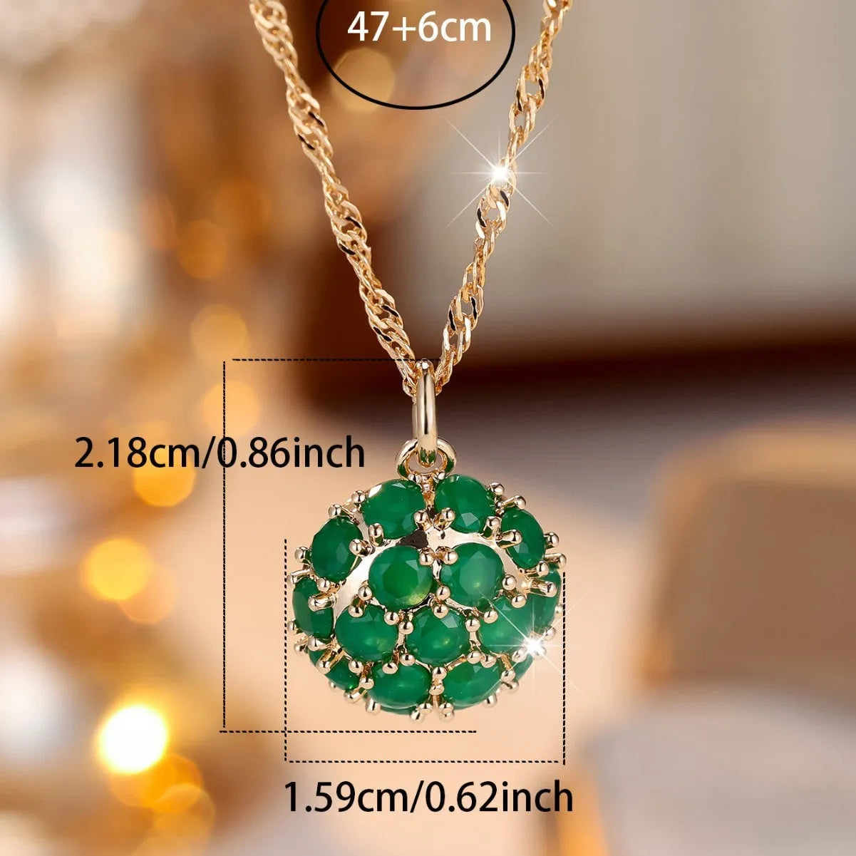Geometric pendant necklace with emerald and diamond detailing on adjustable champagne gold chain