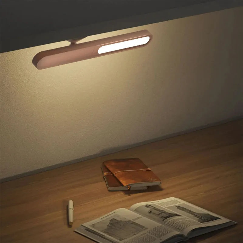 Geometric white desk lamp with magnetic base and USB cable on wooden table
