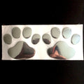 PVC hand-shaped brush dog footprint car sticker on a vehicle bumper in black colour.