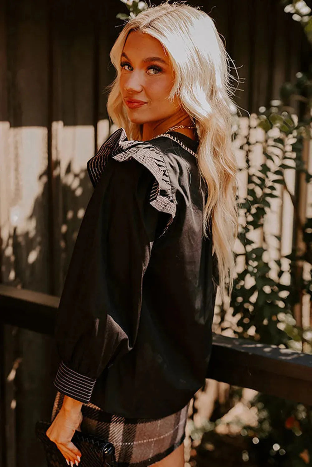 Black women's v-neck blouse with ruffle long sleeves and contrast stitching