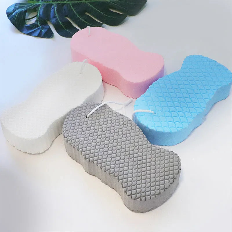3D fish scale pattern bath sponge ball in assorted colours on a bathroom background.