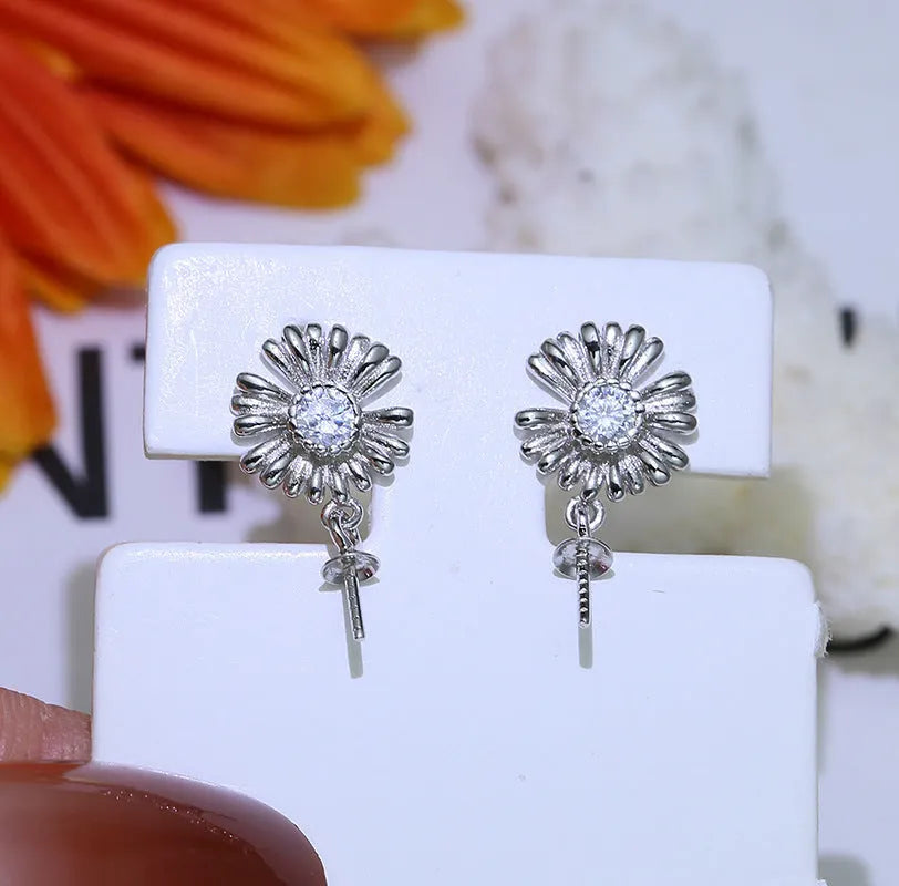 Baroque-style S925 sterling silver floral jewellery holder with pair of earrings on silver frame.