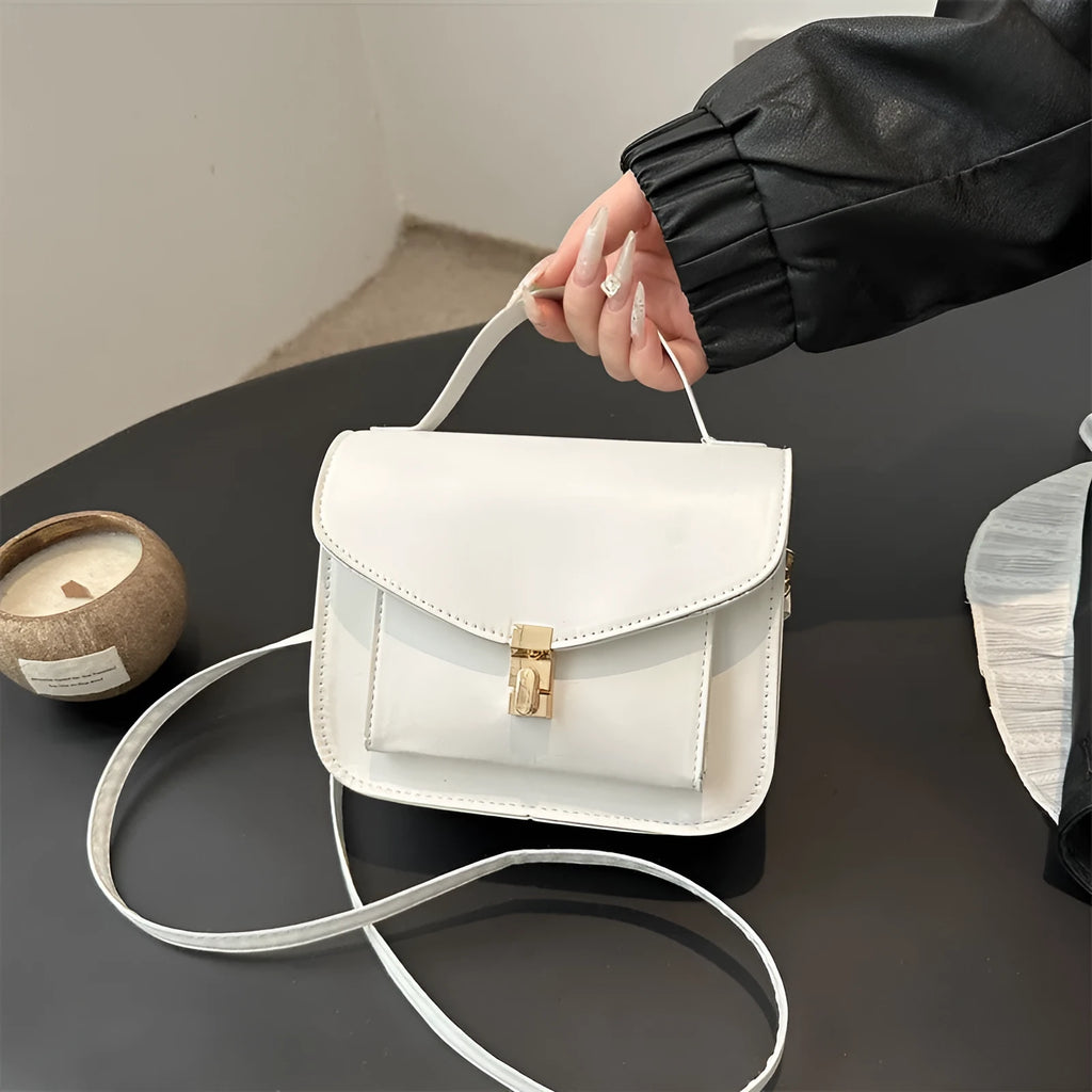 Retro style square messenger bag in PU with a crossbody strap and internal document pocket.