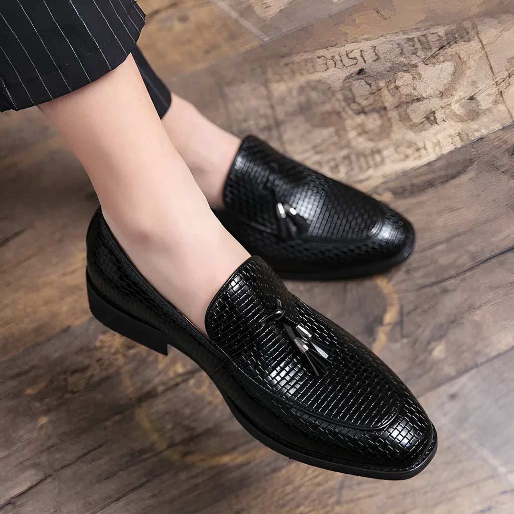 Men's black slip-on business shoes with pointed toe and tassel detail on artificial PU upper
