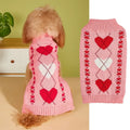Red love heart design dog sweater on a small dog, showing pink bow detail.