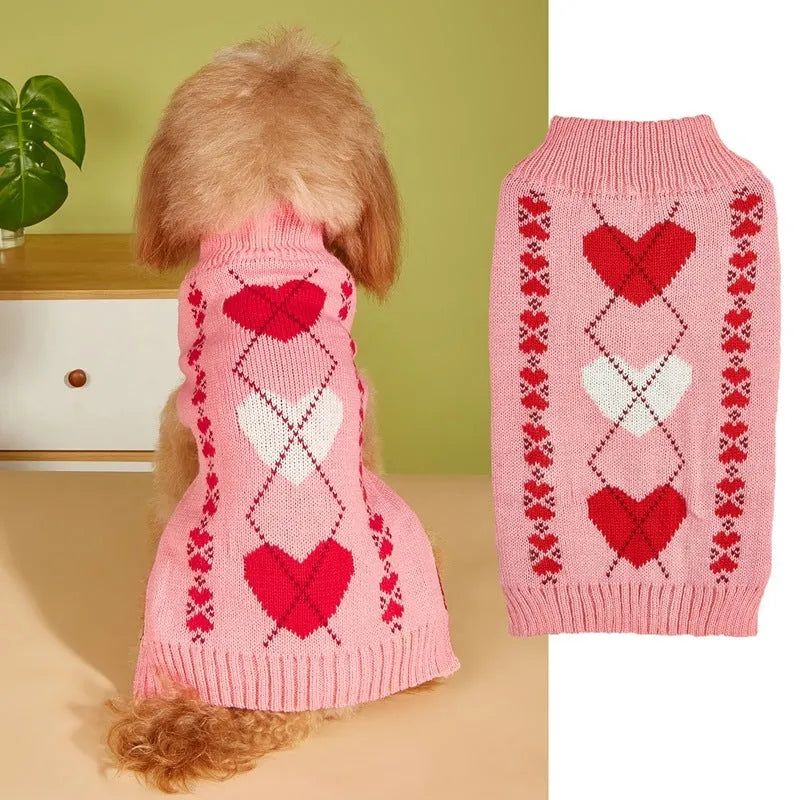 Red love heart design dog sweater on a small dog, showing pink bow detail.