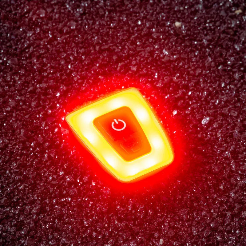 USB rechargeable bicycle taillight in black mounted on helmet with 3 lighting modes