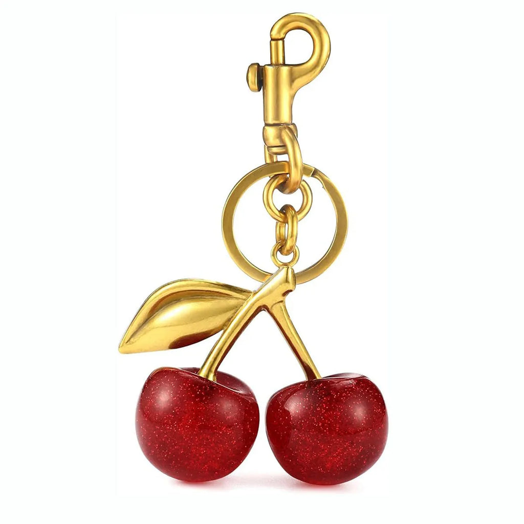 Close-up of a red zinc alloy keychain pendant shaped like a detailed three-dimensional cherry.