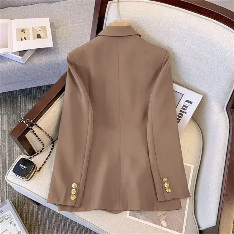 Women's loose-fit polyester blouse in beige, shown on a hanger.