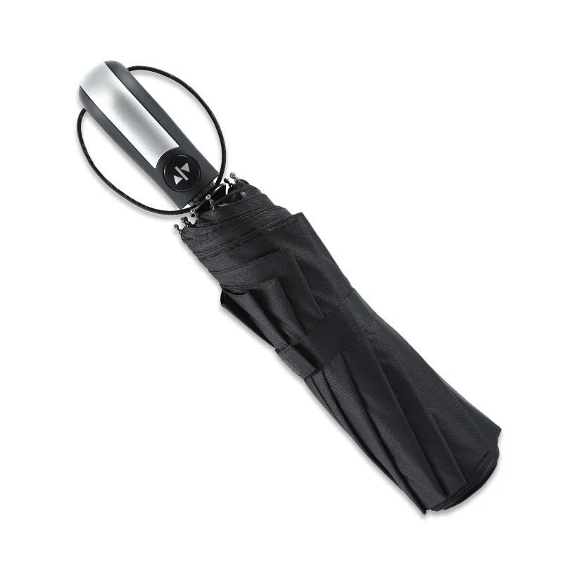 Triple folding automatic black business umbrella with steel ribs and a rubber handle, shown in the open position.