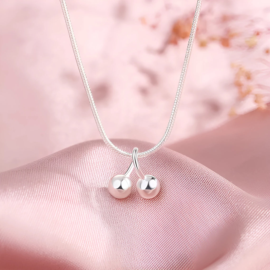 Silver cherry pendant necklace with adjustable snake bone chain on a 21cm to 50cm range.