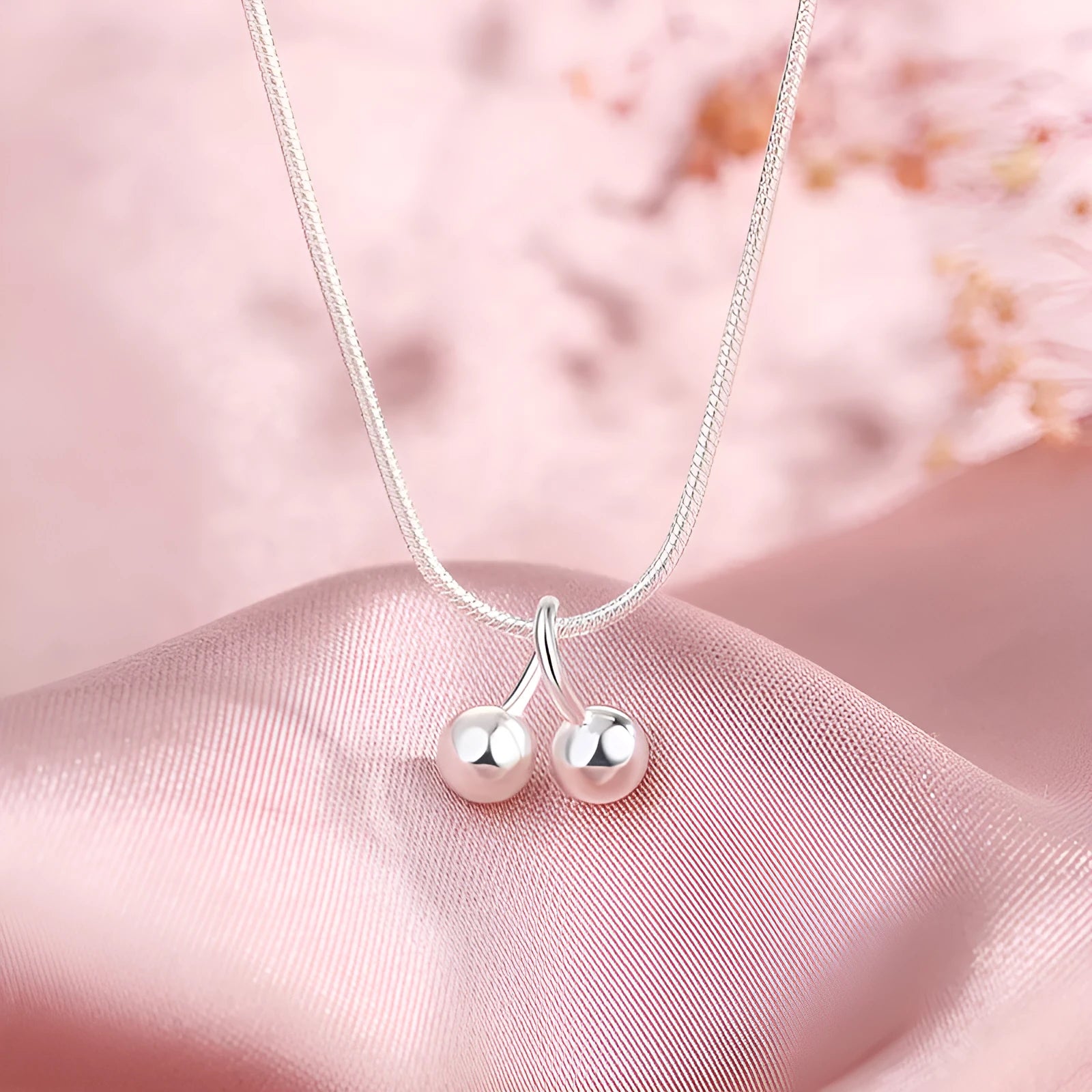 Silver cherry pendant necklace with adjustable snake bone chain on a 21cm to 50cm range.