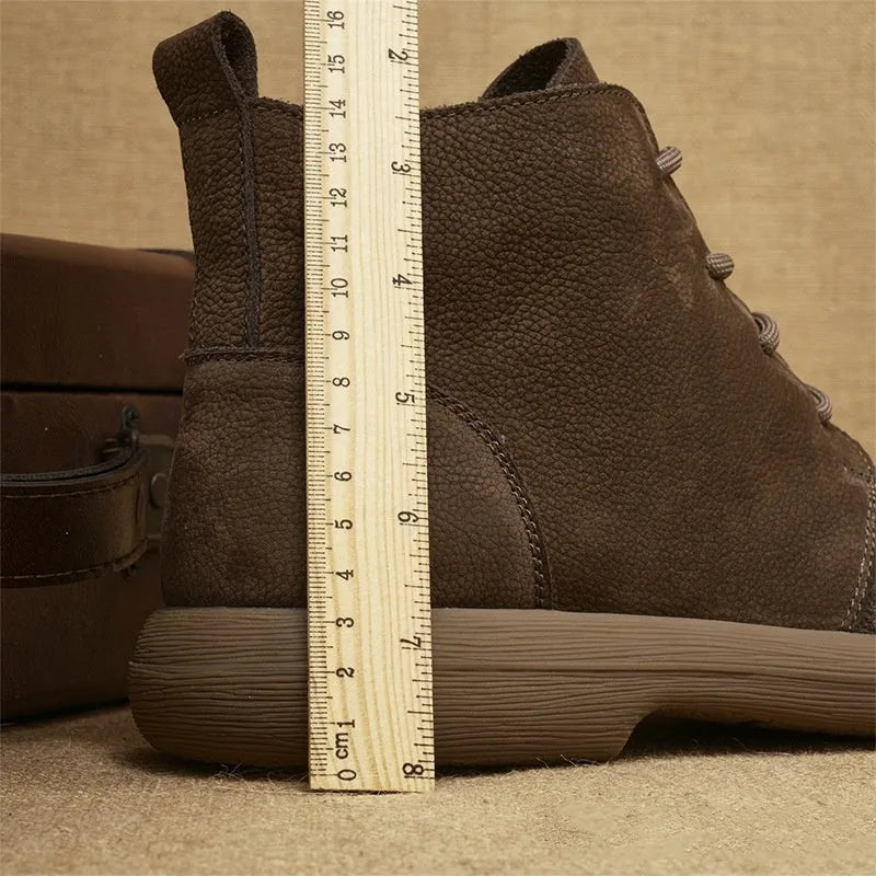 Grey genuine leather martin boots with wedge heel and lace-up front on a white background.