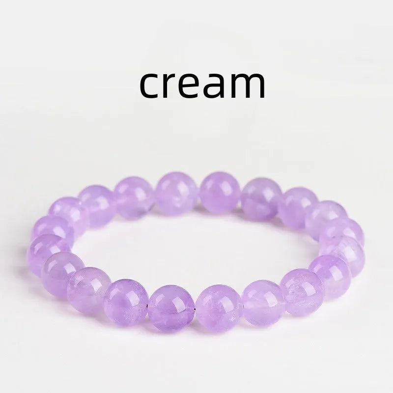 Lavender round amethyst bead bracelet with water ripple design on a wrist.