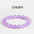 Lavender round amethyst bead bracelet with water ripple design on a wrist.
