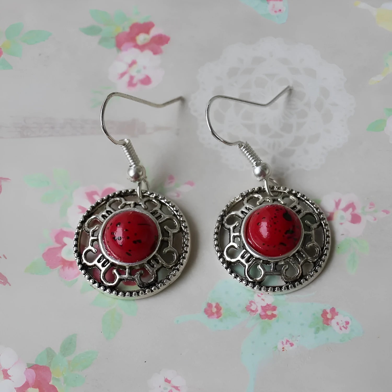 Handmade geometric flower disk earrings in Tibetan silver and turquoise, showing totem patterns.