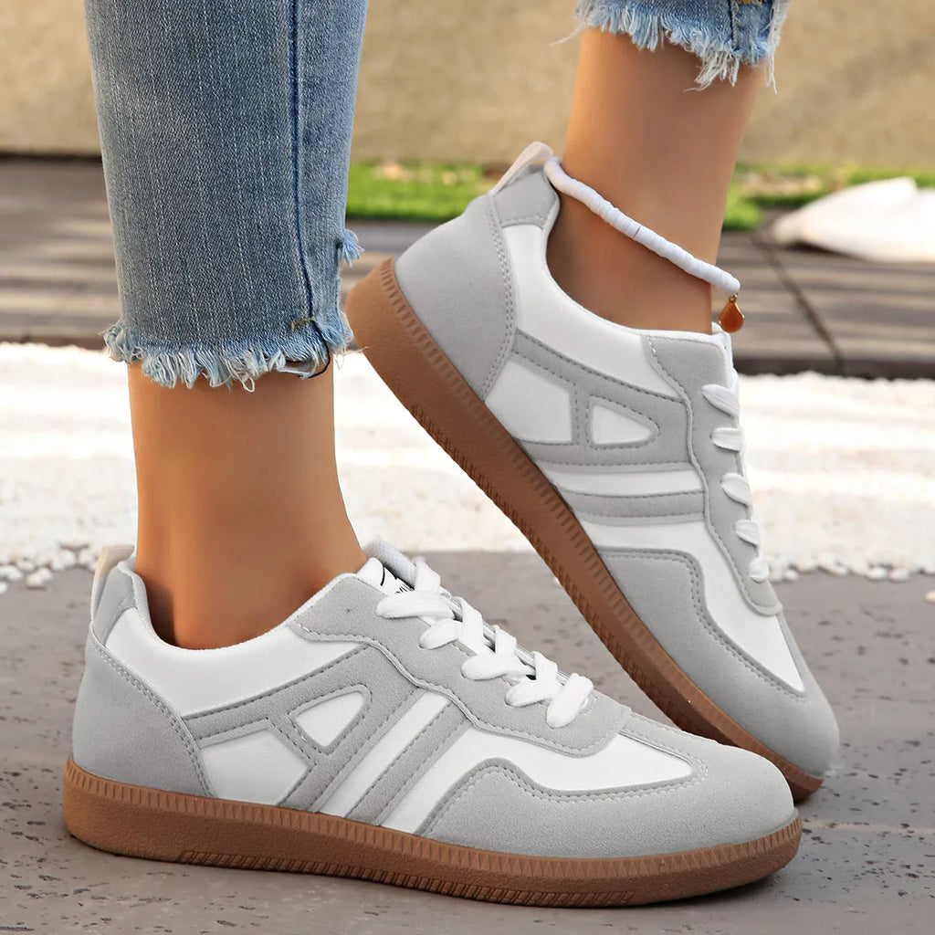 Women's retro colour matching lace-up jogging shoes in black with cross strap and low platform heel.