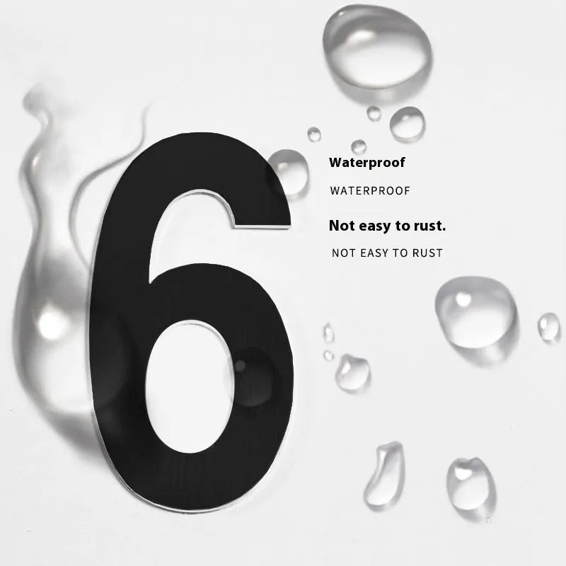 Black stainless steel sticky house number showing 7.5cm height on a door.