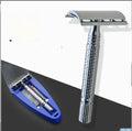 Double edged safety razor with chrome-plated brass handle and closed comb head on a storage box.