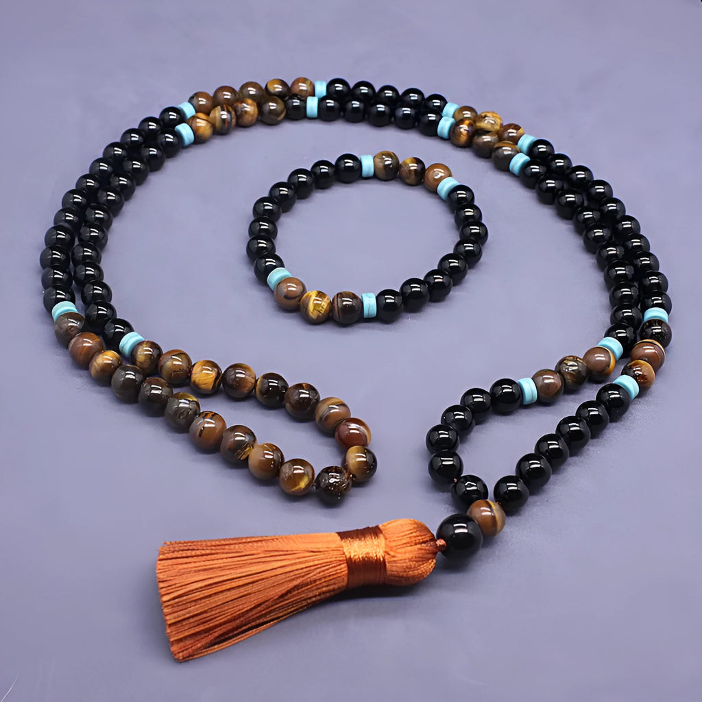 Close-up of black agate and tigereye geometric bead bracelet and necklace set on neutral background
