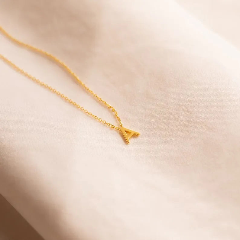 Stainless steel letter necklace with mixed gem inlaid pendant on an adjustable O-ring chain in silver finish