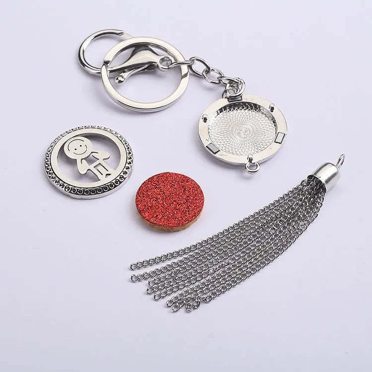 Alloy tassel-style car fragrance pendant with cotton pads hanging from rear-view mirror